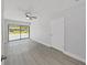Bedroom features luxury vinyl flooring and large windows offering ample natural light at 4652 Swallowtail Dr, New Port Richey, FL 34653
