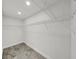 Walk-in closet with custom shelving, providing ample storage space at 4652 Swallowtail Dr, New Port Richey, FL 34653