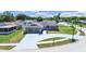 Charming home with stone accents, a well-manicured lawn, a painted driveway, and mature landscaping at 4652 Swallowtail Dr, New Port Richey, FL 34653