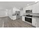 Bright kitchen featuring stainless steel appliances, granite countertops and a view of living room at 4652 Swallowtail Dr, New Port Richey, FL 34653