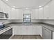 Modern kitchen design boasting stainless steel appliances, granite countertops, and white cabinetry at 4652 Swallowtail Dr, New Port Richey, FL 34653