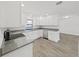 Updated kitchen featuring stainless steel appliances, granite counters, and white cabinetry at 4652 Swallowtail Dr, New Port Richey, FL 34653