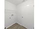 Bright laundry area with clean, white walls and modern vinyl plank flooring at 4652 Swallowtail Dr, New Port Richey, FL 34653