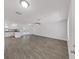Bright, open-concept living area with hardwood floors, white walls, and access to the pool area at 4652 Swallowtail Dr, New Port Richey, FL 34653
