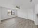 Bright living room featuring modern ceiling fan, hardwood floors, and freshly painted walls at 4652 Swallowtail Dr, New Port Richey, FL 34653