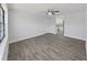 Spacious living room featuring hardwood floors, natural light and an adjoining eat-in kitchen at 4652 Swallowtail Dr, New Port Richey, FL 34653