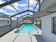 Lovely screened-in pool with clear water and tiled spa, offering a private and relaxing outdoor experience at 4652 Swallowtail Dr, New Port Richey, FL 34653
