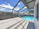 Inviting screened-in pool area featuring clear blue water and an attached tiled spa for ultimate relaxation at 4652 Swallowtail Dr, New Port Richey, FL 34653