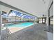 Screened-in patio features a refreshing pool and lounge area at 4652 Swallowtail Dr, New Port Richey, FL 34653