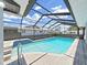 Beautiful screened-in pool featuring cool blue water and a patio with tile accents at 4652 Swallowtail Dr, New Port Richey, FL 34653