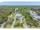 Expansive aerial view of a sprawling estate, showing the meticulously landscaped grounds and lush greenery at 4710 Troydale Rd, Tampa, FL 33615