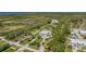 Expansive aerial view of luxury home with lush landscaping, circular drive and waterway in the background at 4710 Troydale Rd, Tampa, FL 33615