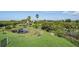 Expansive backyard featuring lush greenery, a serene pond, and mature trees creating a private oasis at 4710 Troydale Rd, Tampa, FL 33615