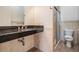 Stylish bathroom featuring a sleek vanity, granite countertop, and a glass-enclosed shower at 4710 Troydale Rd, Tampa, FL 33615
