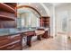 Elegant bathroom featuring dual sinks, granite countertops, and custom wood cabinetry at 4710 Troydale Rd, Tampa, FL 33615