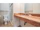 Bathroom with a beautiful marble countertop, decorative tiling, and a glass-enclosed shower at 4710 Troydale Rd, Tampa, FL 33615