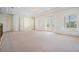 Bright and spacious bedroom with plush carpeting, white trim, tray ceiling and balcony access at 4710 Troydale Rd, Tampa, FL 33615
