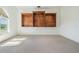 Versatile bonus room with built-in shelving, carpet, and large window for natural light at 4710 Troydale Rd, Tampa, FL 33615