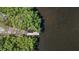 Aerial view showcasing a private dock extending into the calm waters surrounded by lush green mangroves at 4710 Troydale Rd, Tampa, FL 33615