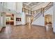 Grand foyer with a striking staircase and high ceilings, bathed in natural light at 4710 Troydale Rd, Tampa, FL 33615