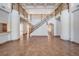 Grand foyer showcasing a sweeping staircase, tile flooring, and soaring ceilings with detailed millwork at 4710 Troydale Rd, Tampa, FL 33615