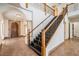 Grand foyer with a striking staircase, arched doorways, and elegant tile flooring at 4710 Troydale Rd, Tampa, FL 33615