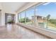 Hallway with tile flooring and expansive windows overlooking cabana and lush landscaping at 4710 Troydale Rd, Tampa, FL 33615