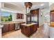 Modern kitchen features dark cabinetry, stainless steel appliances, a center island, and ample counter space at 4710 Troydale Rd, Tampa, FL 33615