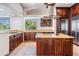Gourmet kitchen featuring custom cabinetry, granite countertops, and stainless steel appliances at 4710 Troydale Rd, Tampa, FL 33615