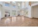 Bright and airy living room with soaring ceilings, large windows, and travertine flooring at 4710 Troydale Rd, Tampa, FL 33615