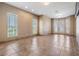 Spacious living room with tile floors, neutral paint, and large windows offering natural light at 4710 Troydale Rd, Tampa, FL 33615
