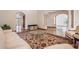 Open-concept living area featuring tile flooring, arched doorways, columns, and ample space for entertaining at 4710 Troydale Rd, Tampa, FL 33615