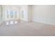 Bright and airy living room with large windows and elegant chandelier, creating a welcoming atmosphere at 4710 Troydale Rd, Tampa, FL 33615