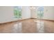 Spacious room with tile floors, large windows with bright natural light, and an elegant chandelier at 4710 Troydale Rd, Tampa, FL 33615