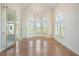 Bright living room with tiled floors, arched windows, and glass doors leading to an outdoor space at 4710 Troydale Rd, Tampa, FL 33615