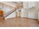 Open living space with soaring ceilings, tile flooring, grand staircase, and lots of natural light at 4710 Troydale Rd, Tampa, FL 33615