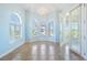 Living room boasting arched windows and glass doors, allowing natural light and scenic views at 4710 Troydale Rd, Tampa, FL 33615