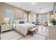 Bright main bedroom featuring a king bed, sitting area, and multiple windows offering serene views at 4710 Troydale Rd, Tampa, FL 33615
