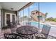 Covered patio with outdoor seating overlooking the sparkling pool and cabana at 4710 Troydale Rd, Tampa, FL 33615
