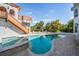 Outdoor pool and spa area with brick patio, complemented by lush tropical landscaping at 4710 Troydale Rd, Tampa, FL 33615