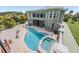 Backyard aerial view of a large private pool, spa, cabana, and lush landscaping at 4710 Troydale Rd, Tampa, FL 33615