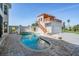 Beautiful outdoor pool area with a spa, pergola-covered seating, and well-manicured landscaping at 4710 Troydale Rd, Tampa, FL 33615