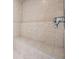 Large tile shower with seating, dual shower heads, and high end shower fixtures at 4710 Troydale Rd, Tampa, FL 33615