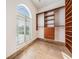 Spacious walk-in closet with custom shelving, drawers, and a large arched window at 4710 Troydale Rd, Tampa, FL 33615