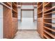 Spacious walk-in closet with custom built-in shelving and drawers for ample storage at 4710 Troydale Rd, Tampa, FL 33615
