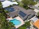 Aerial view of backyard featuring a pool, solar panels, a patio, and lush landscaping in a private backyard at 4739 114Th N St, St Petersburg, FL 33708