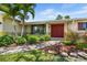 Inviting entrance of a home showcasing lush landscaping, with a well-maintained walkway leading to double doors at 4739 114Th N St, St Petersburg, FL 33708