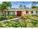 Beautiful home featuring a charming front garden and double front doors, inviting warmth and curb appeal at 4739 114Th N St, St Petersburg, FL 33708