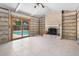 Cozy living room featuring a brick fireplace, tile floors, and sliding door to the pool at 4739 114Th N St, St Petersburg, FL 33708