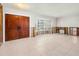 Spacious living room with new tile flooring, large windows, and double doors, awaiting your personal design touches at 4739 114Th N St, St Petersburg, FL 33708